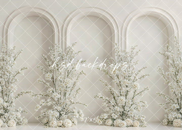 Ivory floral triple arch photography backdrop with elegant white flowers and architectural arches for Mother’s Day and maternity portrait photography.