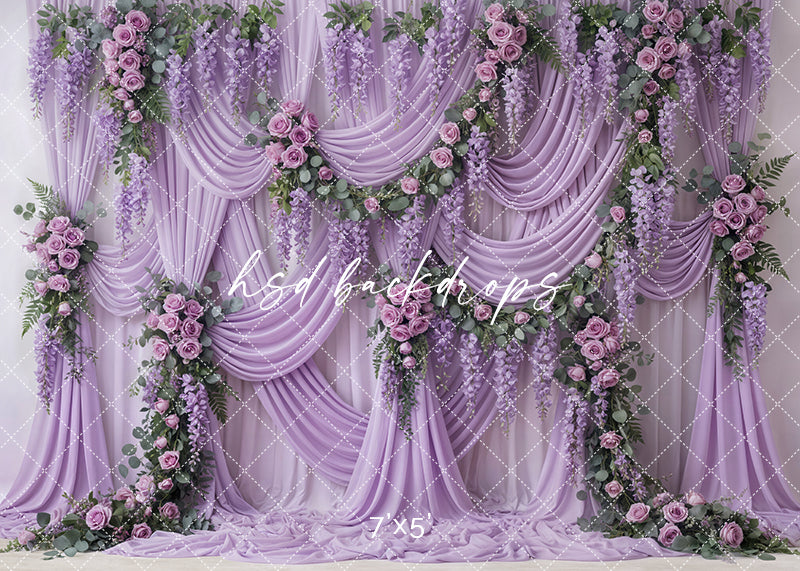 Lavender wisteria draped floral photography backdrop with cascading purple flowers, mauve roses, and flowing lavender fabric for Mother’s Day portraits.