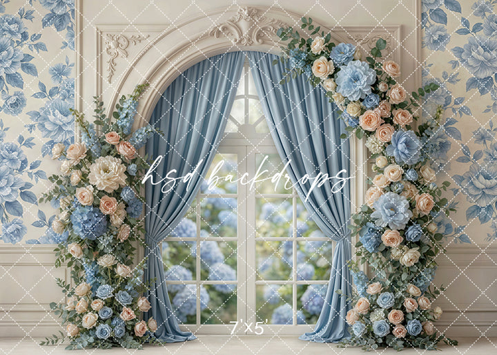 Blue garden window floral photography backdrop with pastel florals, elegant blue drapery, and arched window for Mother’s Day portraits.