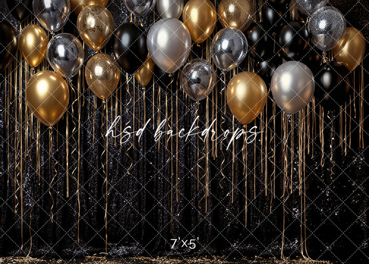New Year’s Eve photography backdrop with gold, silver, and black balloons over a shimmering black sequin background.
