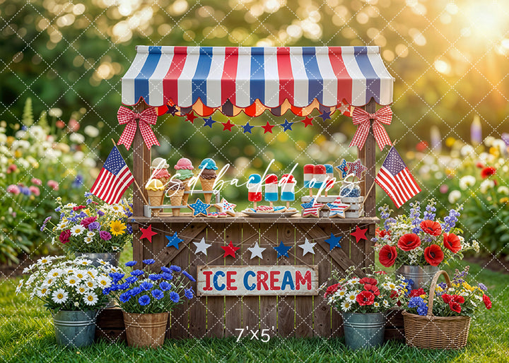 Fourth of July ice cream stand photography backdrop with American flags, red white and blue decor, and colorful popsicles for summer portraits.