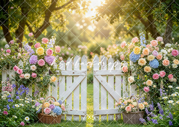 Pastel garden gate photography backdrop with a white picket gate, soft spring florals, and a romantic sunlit garden setting for portrait photography.