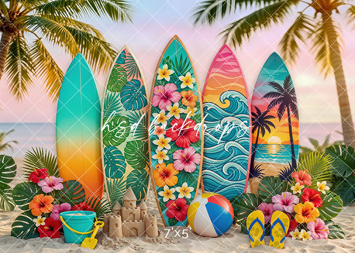 Sunset surfboard photography backdrop with colorful surfboards, tropical flowers, palm trees, and a sandy beach setting for summer portrait photography.