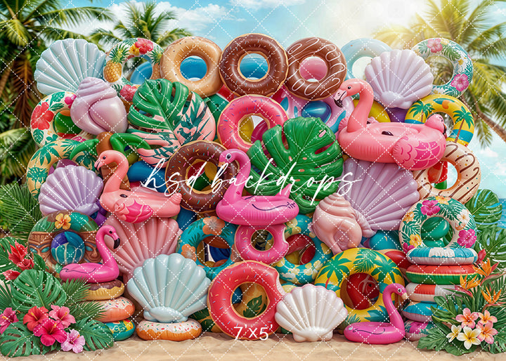 Tropical summer floatie wall photography backdrop with colorful pool floats, flamingos, seashells, tropical leaves, and beach-inspired decor for summer portrait photography.