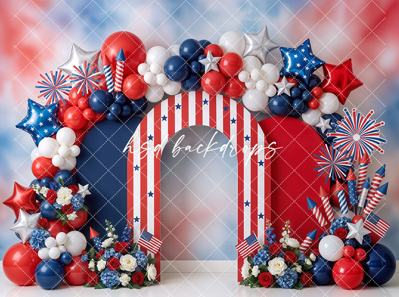 Patriotic balloon arch photography backdrop with red, white, and blue balloons, striped archway, star balloons, fireworks accents, and floral details for Fourth of July portraits.