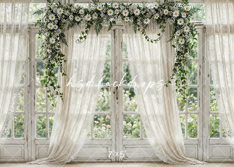 Elegant spring window backdrop with white daisies, greenery, ivory curtains, and vintage trim