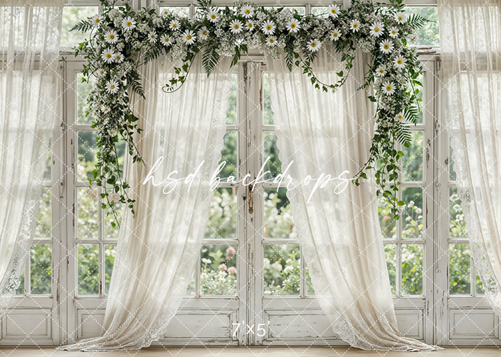 Elegant spring window backdrop with white daisies, greenery, ivory curtains, and vintage trim