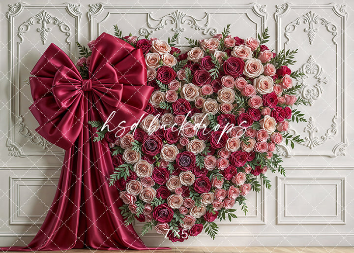 romantic blush and burgundy heart-shaped floral wall with satin bow for photography