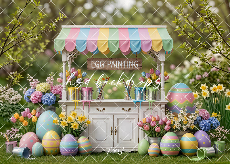 Pastel Easter egg painting cart with colorful oversized eggs, tulips, daffodils, and spring garden scenery for children’s photography.