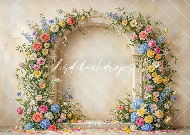 Colorful botanical arch photography backdrop with pastel roses, hydrangeas, daisies, and greenery for spring portrait photography.