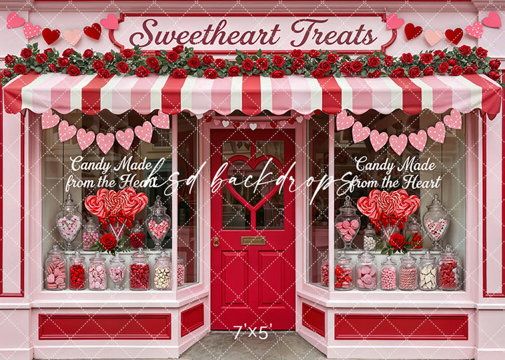 Valentine’s candy shop backdrop with pink and red awning, heart garlands, roses, and jars of sweets