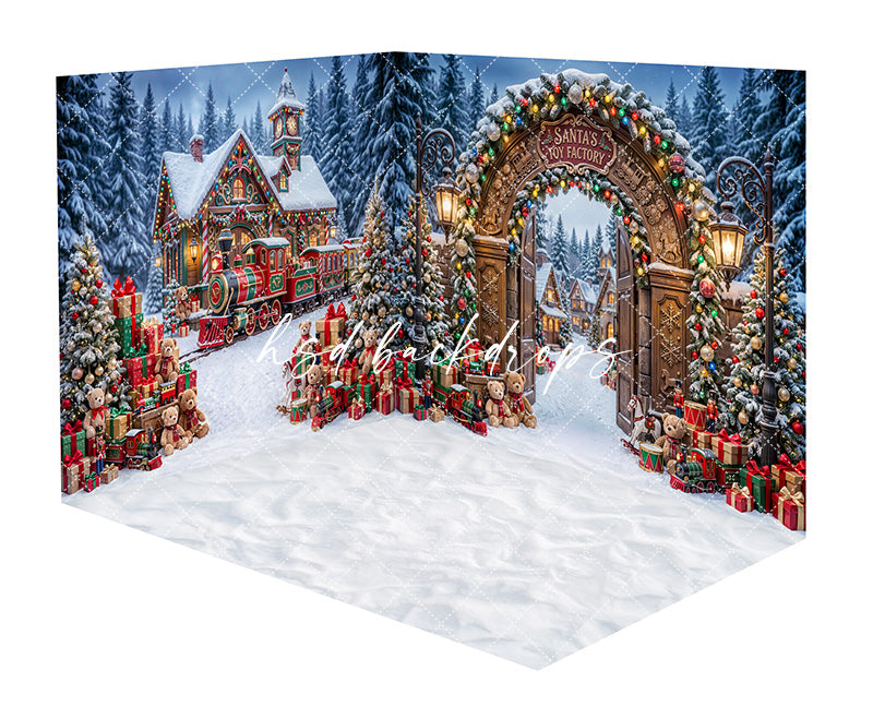 Santa’s Toy Factory Gate Room Photography Backdrop featuring a grand decorated toy factory gate, snowy evergreen trees, glowing lanterns, toy trains, wrapped gifts, and a storybook Christmas village scene for holiday portraits.