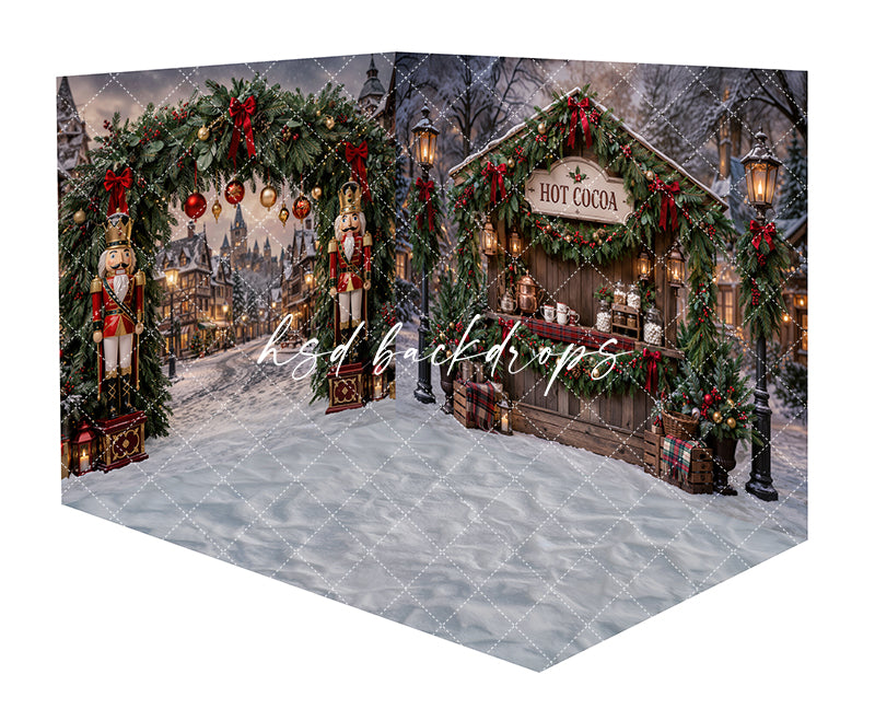 Christmas Hot Cocoa Stand Room Photography Backdrop featuring a snowy holiday market with a festive cocoa booth, nutcracker figures, glowing lanterns, garland, wrapped gifts, and snowy village details for Christmas portraits.