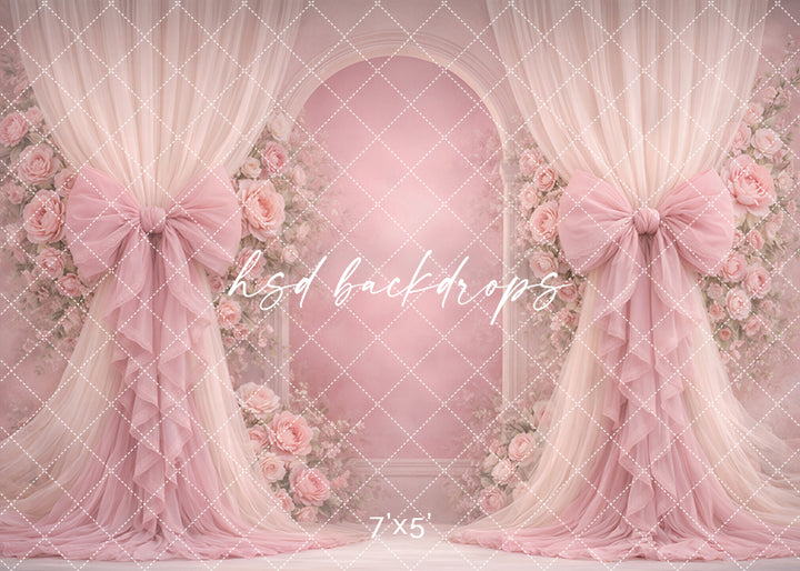 Blush pink rose bow photography backdrop with romantic floral arch and soft draped curtains for elegant portrait sessions.