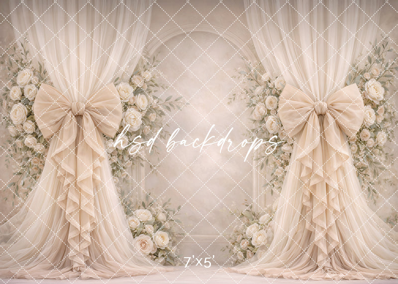 Neutral ivory rose bow photography backdrop with elegant floral arch and flowing drapery for heirloom portrait sessions.