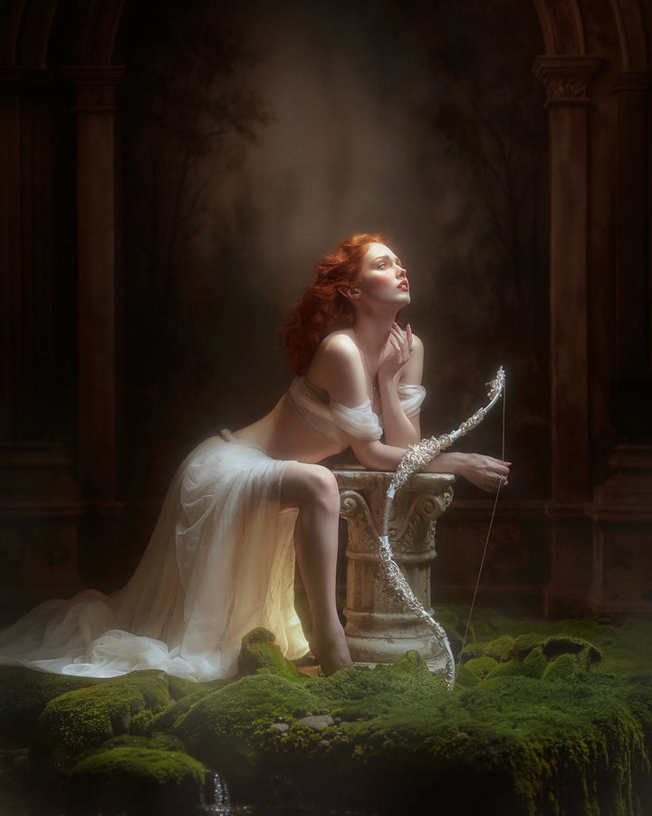Moody woodland arch fine art photography backdrop with dark architectural columns, shadowed forest, soft glowing light, moss-covered ground, and dramatic painterly portrait styling.