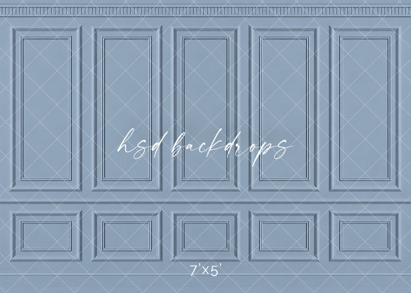 Dusty French Blue Panel photography backdrop featuring traditional French-inspired boiserie wall molding, five tall symmetrical rectangular panels, ornate dentil-style crown molding, a classic chair rail, and coordinating lower wainscoting in a soft muted French blue finish for fine art, maternity, newborn, and elegant studio portraits.