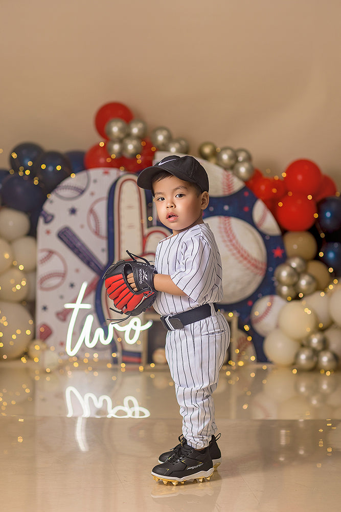 All Star 1st Birthday photography backdrop with red, navy, and white balloons, oversized baseballs, foam finger number one, and sports-themed birthday decor for boys portraits.
