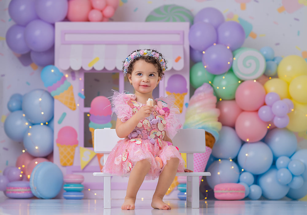 Pastel Sweet Scoops photography backdrop with a pastel ice cream stand, colorful balloon clusters, ice cream cone accents, candy details, and sweet birthday styling for girls portraits.