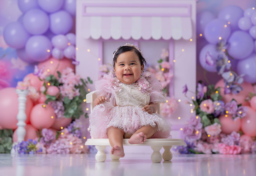 Lavender Blossom Window photography backdrop with a pastel lavender window frame, pink and purple balloon clusters, and soft floral arrangements for girls portrait photography.