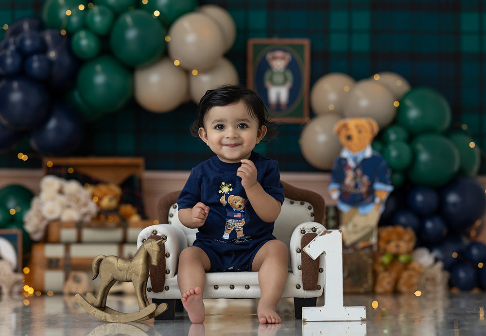 Classy Boy birthday photography backdrop with navy, green, and cream balloons, plaid background, vintage suitcases, books, teddy bears, and elegant birthday styling for boys portraits.