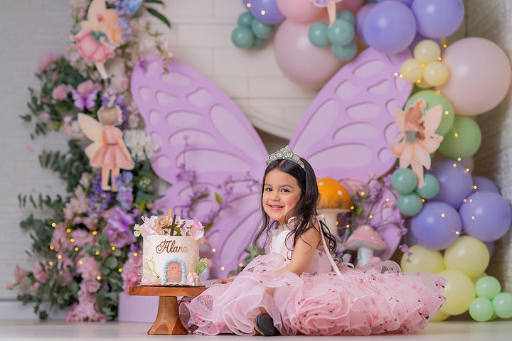 Lavender Fairy Butterfly photography backdrop with oversized lavender butterfly wings, pastel balloons, fairy illustrations, flowers, mushrooms, and whimsical garden styling for portrait photography.
