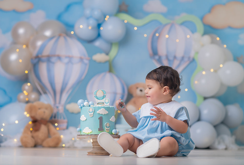 Sky High Teddy Bear photography backdrop with pastel hot air balloons, soft blue sky, cloud details, teddy bears, balloon garlands, stars, and dreamy children’s birthday portrait styling.