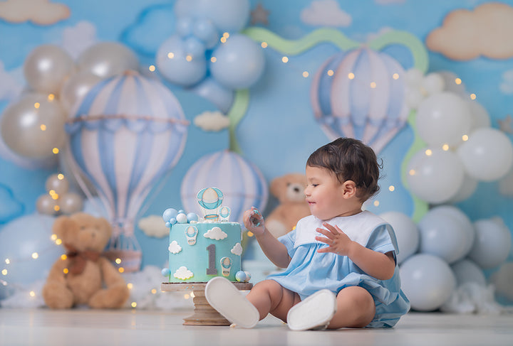 Sky High Teddy Bear photography backdrop with pastel hot air balloons, soft blue sky, cloud details, teddy bears, balloon garlands, stars, and dreamy children’s birthday portrait styling.