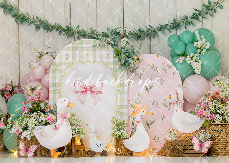 Pastel Goose Party photography backdrop with white geese, pink and mint balloons, gingham panels, floral arrangements, greenery, butterflies, and whimsical garden birthday décor.