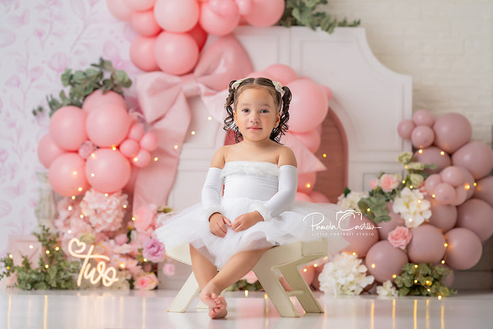Blush Blossom Archway backdrop with pink and mauve balloons, florals, and white arch.
