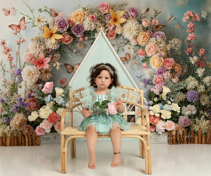 Butterfly Cottage Garden backdrop with pastel roses, butterflies, and blue cottage façade.