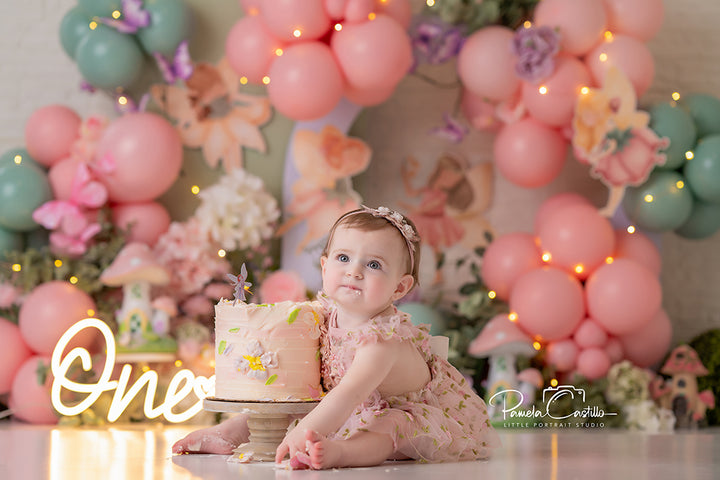 Fairy Blossom Balloon Garden backdrop with pastel balloons, flowers, fairy lights, and whimsical fairies.