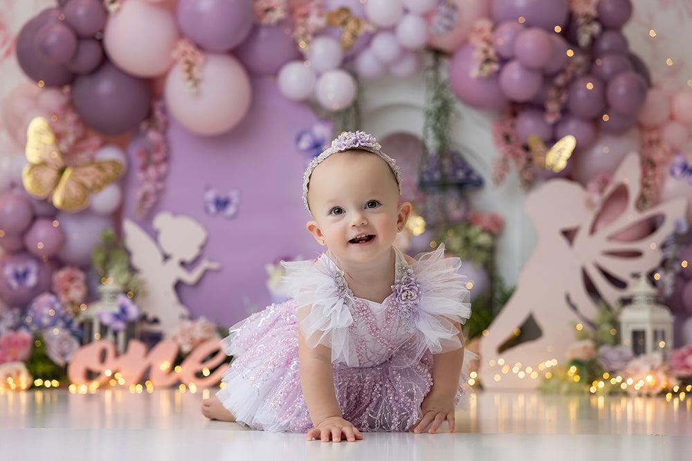 Pixie Party backdrop with pastel balloons, butterflies, florals, and fairy silhouettes.