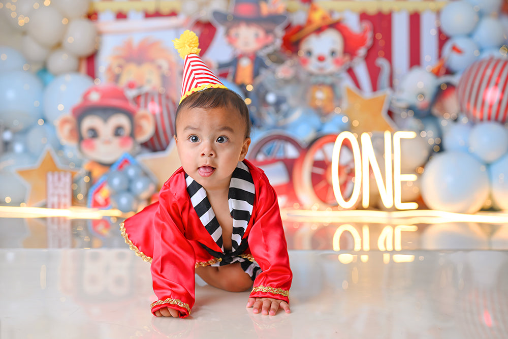 Circus-themed first birthday cake smash backdrop with big top tent and carnival characters