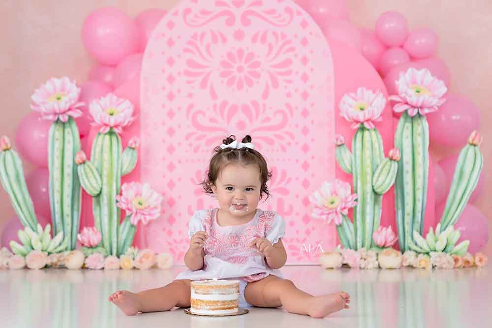 Cactus Cutie backdrop with watercolor cacti, pink balloons, and fiesta arch