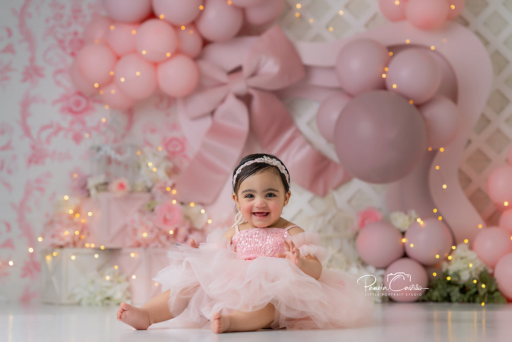 Blushing Elegance pink bow cake smash photography backdrop with florals and balloons.