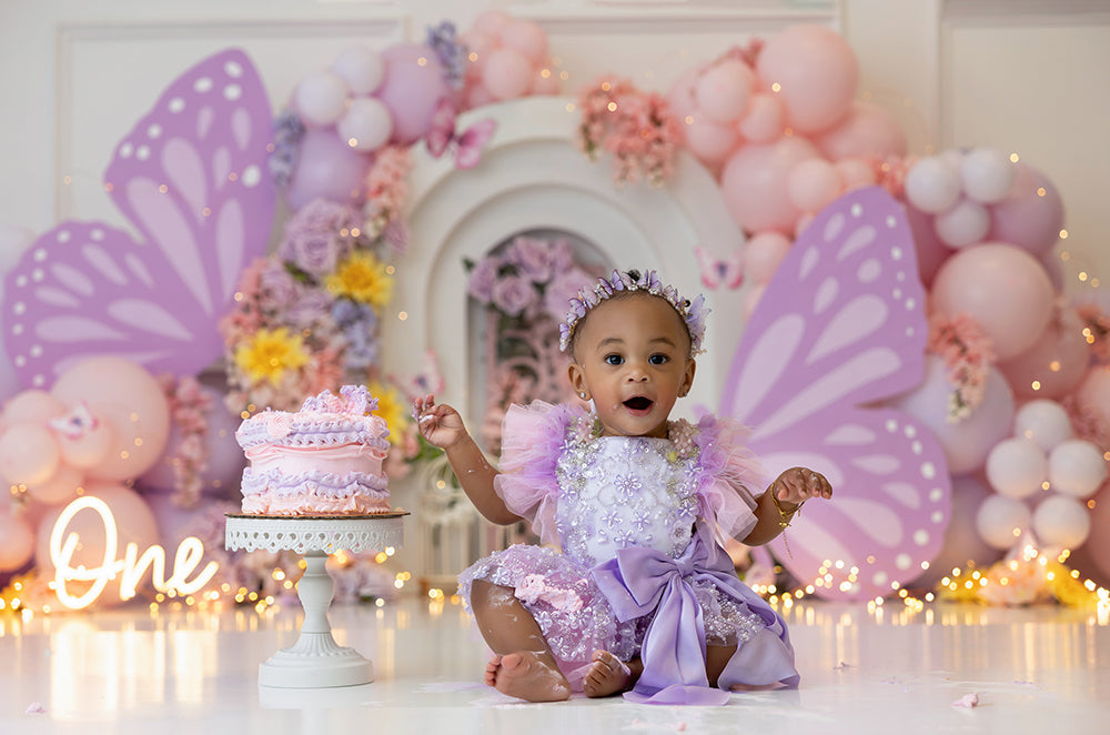 Fluttering Blossom Garden photography backdrop with pink and purple butterfly wings, pastel balloons, and floral arch.