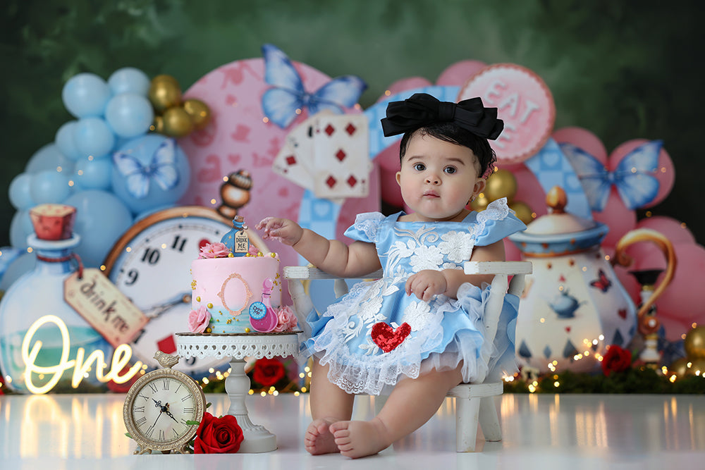 Wonderland Tea Party backdrop with balloons, butterflies, teapot and clock decorations.