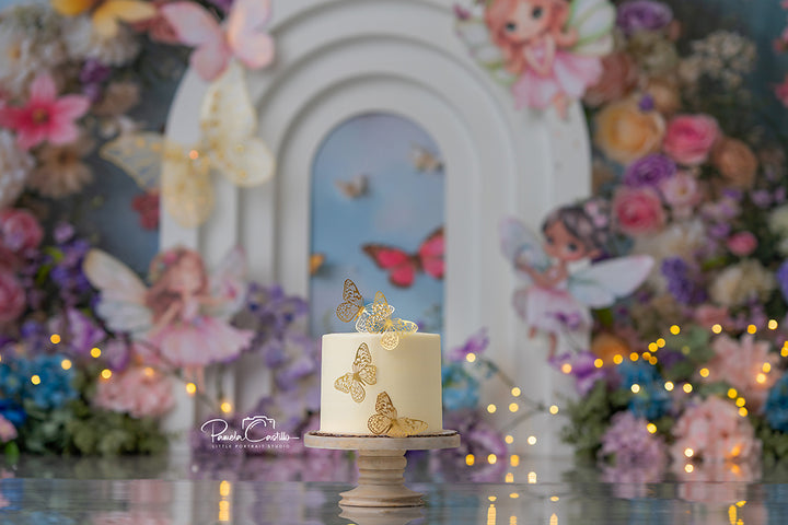 Pastel floral fairy photography backdrop with whimsical fairies, butterflies, and a white enchanted arch surrounded by colorful garden blooms.