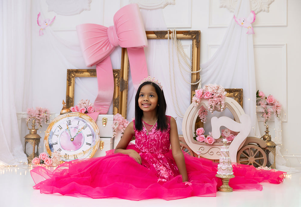 Pink royal fairytale princess carriage photography backdrop with pink bow, gold frames, flowers, and fairytale décor for birthday and cake smash photos.
