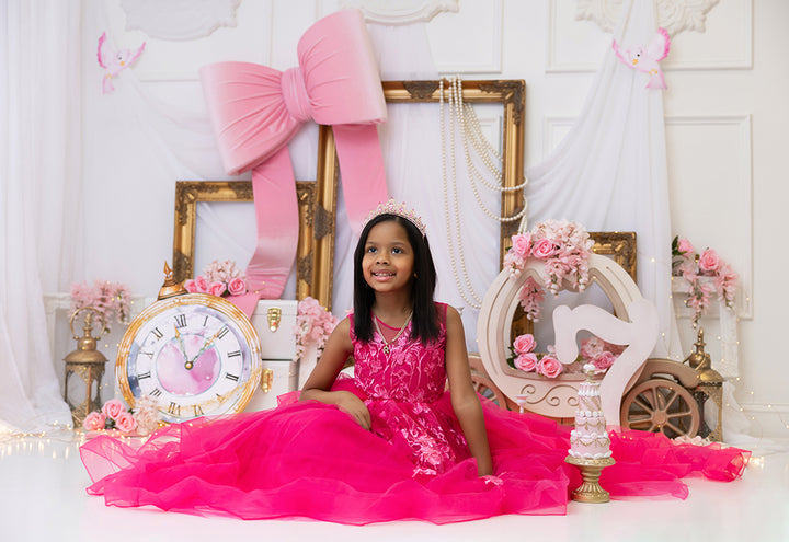 Pink royal fairytale princess carriage photography backdrop with pink bow, gold frames, flowers, and fairytale décor for birthday and cake smash photos.