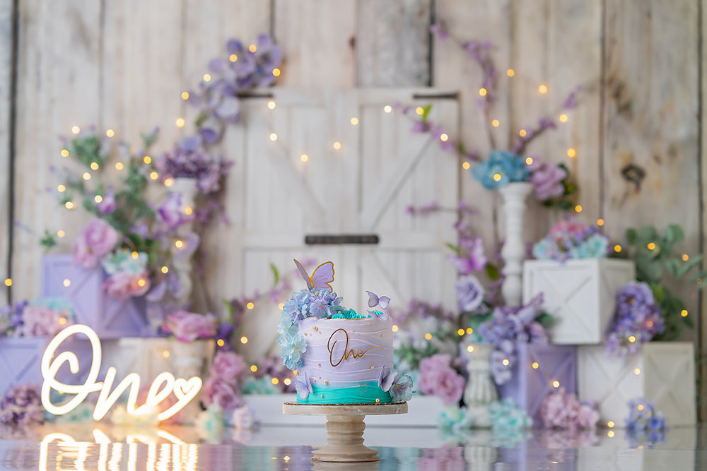Pastel lavender barn door cake smash photography backdrop with soft floral accents, girl first birthday portrait background.