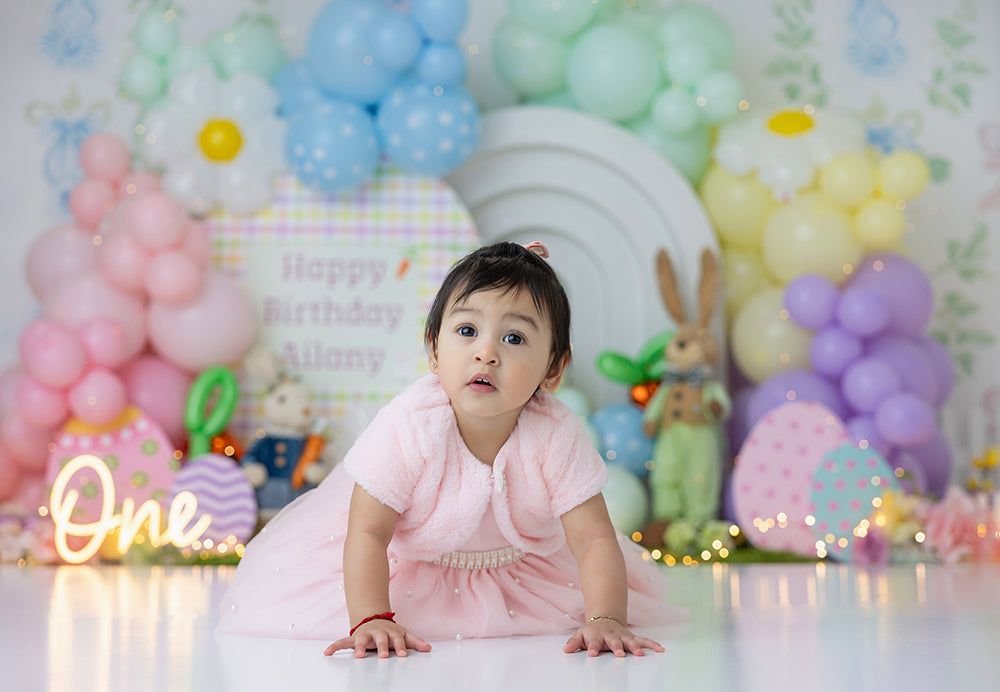 Pastel bunny balloon cake smash photography backdrop with Easter eggs, bunny accents, and soft balloon clusters for spring first birthday sessions.