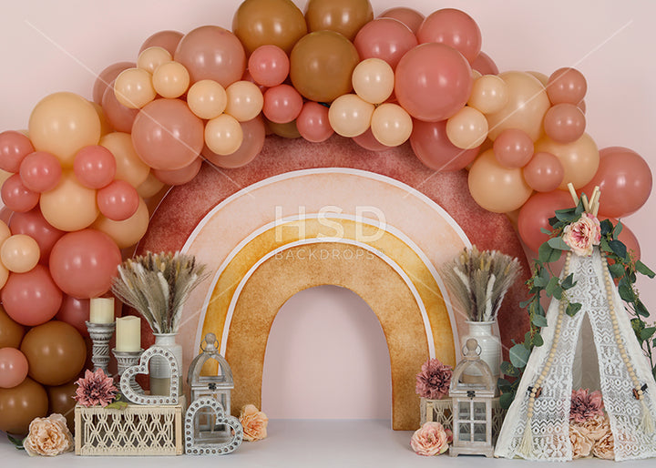Boho themed backdrop with balloon garland for birthday cake smash photos